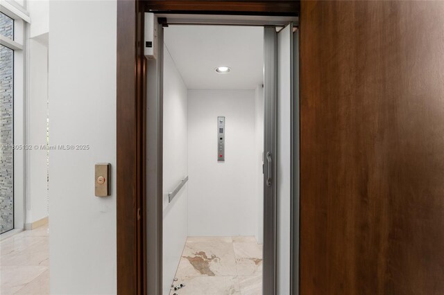 544 Fernwood Rd Unit 544, Key Biscayne, FL 33149 - corridor featuring elevator and light marble finish flooring