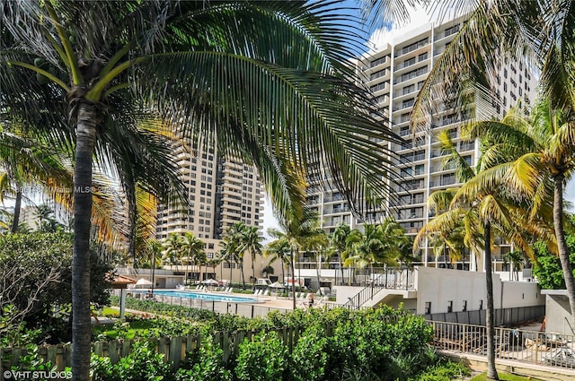 2625 Collins Ave Unit 1409, Miami Beach, FL 33140 - view of building exterior featuring fence and a community pool