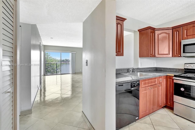 8720 N Sherman Cir Unit 401, Miramar, FL 33025 - kitchen featuring appliances with stainless steel finishes, a textured ceiling, light tile patterned floors, and dark brown cabinets