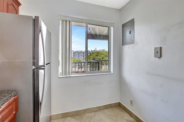 8720 N Sherman Cir Unit 401, Miramar, FL 33025 - kitchen with freestanding refrigerator, electric panel, healthy amount of natural light, and light tile patterned floors
