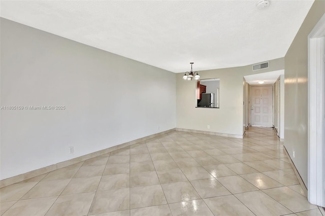 8720 N Sherman Cir Unit 401, Miramar, FL 33025 - unfurnished room featuring a chandelier, light tile patterned floors, and a smoke detector
