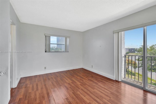 8720 N Sherman Cir Unit 401, Miramar, FL 33025 - spare room featuring wood finished floors and a textured ceiling