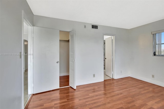 8720 N Sherman Cir Unit 401, Miramar, FL 33025 - unfurnished bedroom with wood finished floors and a closet