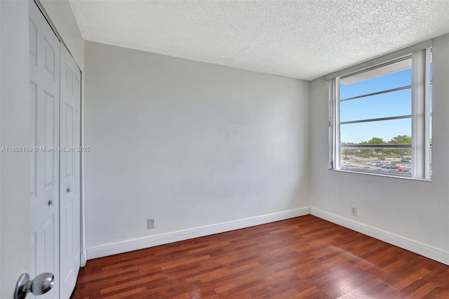 8720 N Sherman Cir Unit 401, Miramar, FL 33025 - unfurnished bedroom with wood finished floors, a textured ceiling, and a closet