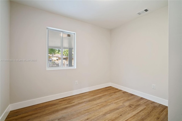 empty room featuring baseboards and wood finished floors