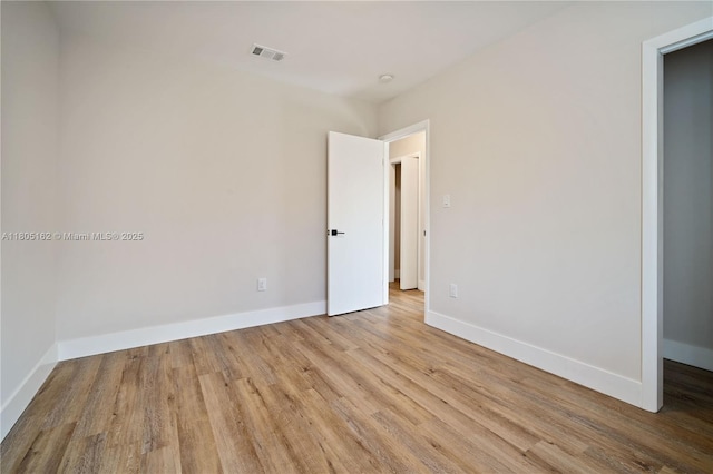 empty room with wood finished floors and baseboards