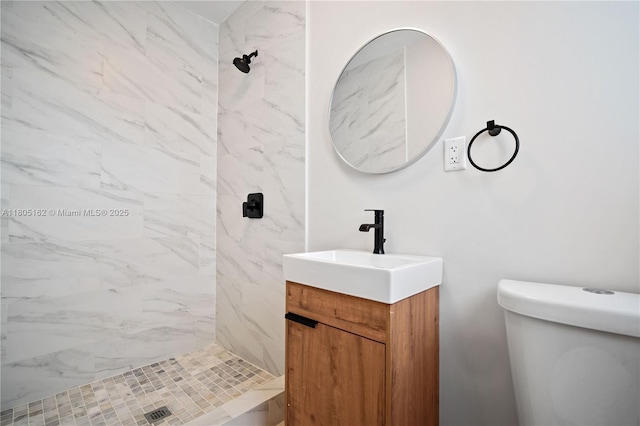 full bath with vanity, a shower stall, and toilet