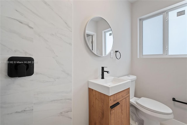 bathroom featuring toilet and vanity