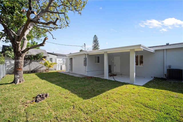 back of property with stucco siding, a patio, cooling unit, and an attached carport