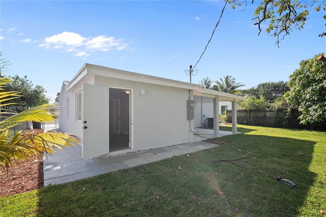 rear view of property featuring stucco siding and a patio