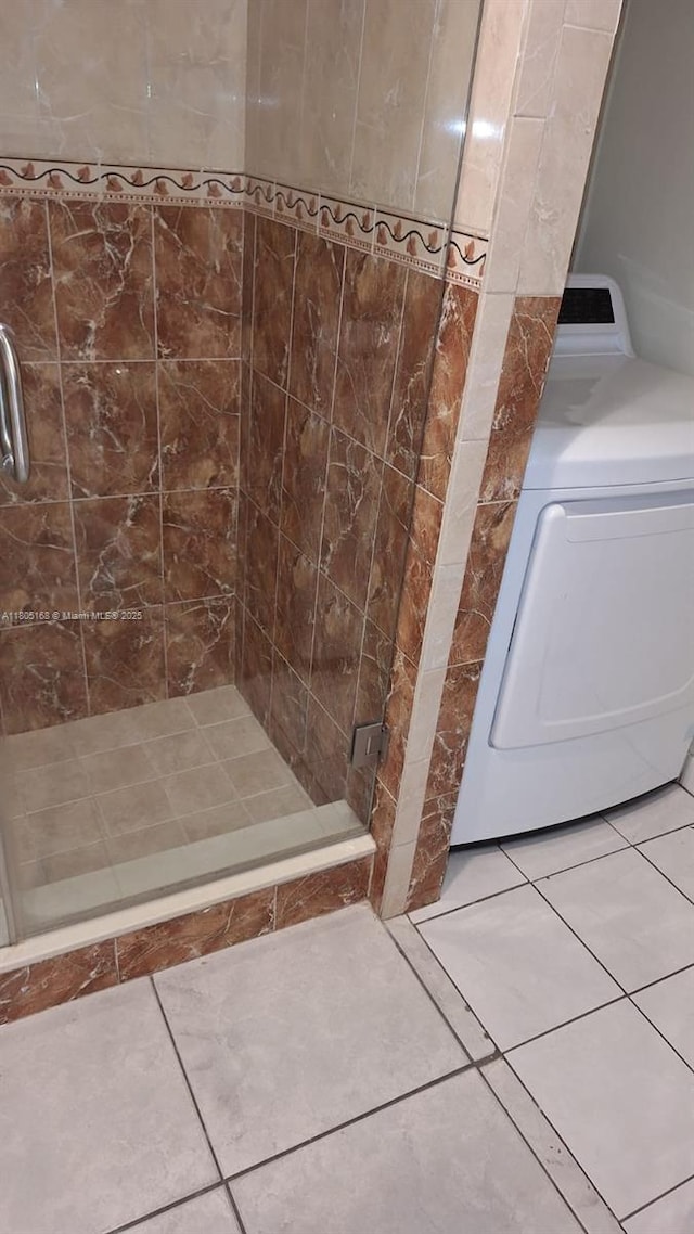 1670 Forest Lakes Cir Unit C, West Palm Beach, FL 33406 - bathroom with washer / clothes dryer, tile patterned floors, and a shower stall