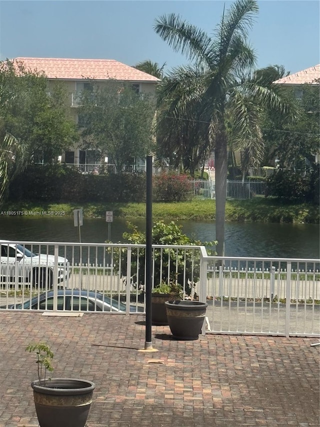 2025 NE 164th St Unit 206, North Miami Beach, FL 33162 - view of patio featuring a water view and fence