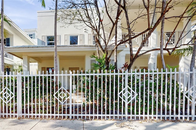 931 SW 11th St Unit H-1, Miami, FL 33129 - view of front facade featuring stucco siding and a fenced front yard