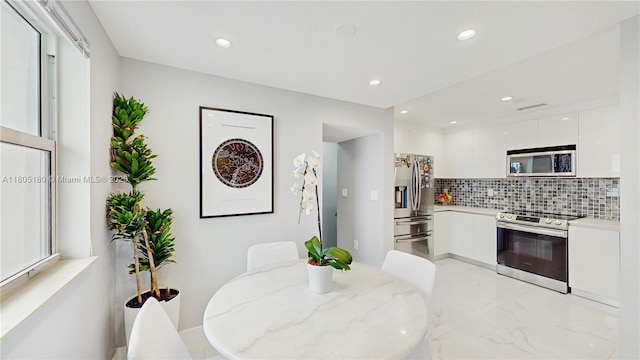 931 SW 11th St Unit H-1, Miami, FL 33129 - kitchen featuring appliances with stainless steel finishes, modern cabinets, white cabinets, backsplash, and recessed lighting