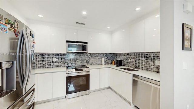 931 SW 11th St Unit H-1, Miami, FL 33129 - kitchen with appliances with stainless steel finishes, a sink, modern cabinets, white cabinetry, and recessed lighting