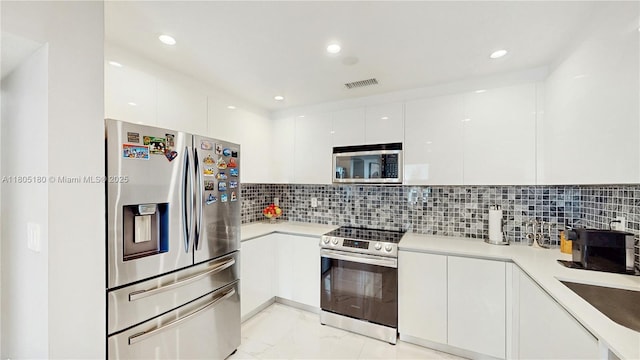 931 SW 11th St Unit H-1, Miami, FL 33129 - kitchen featuring stainless steel appliances, modern cabinets, white cabinetry, light marble finish flooring, and recessed lighting