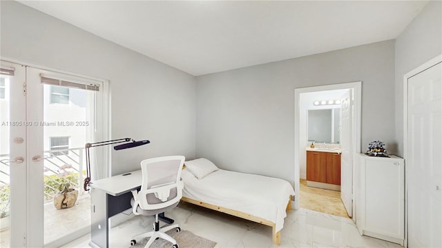 931 SW 11th St Unit H-1, Miami, FL 33129 - bedroom with light marble finish floors, a desk, connected bathroom, and french doors