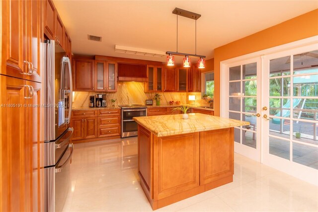 15332 SW 142nd Ter, Miami, FL 33196 - kitchen with stainless steel appliances, brown cabinetry, light stone counters, tasteful backsplash, and french doors