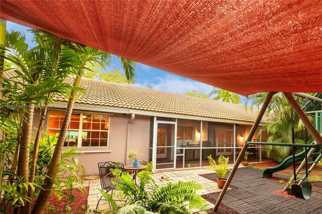 15332 SW 142nd Ter, Miami, FL 33196 - view of patio / terrace featuring a sunroom