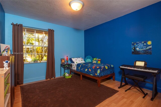 15332 SW 142nd Ter, Miami, FL 33196 - bedroom featuring wood finished floors and a textured ceiling