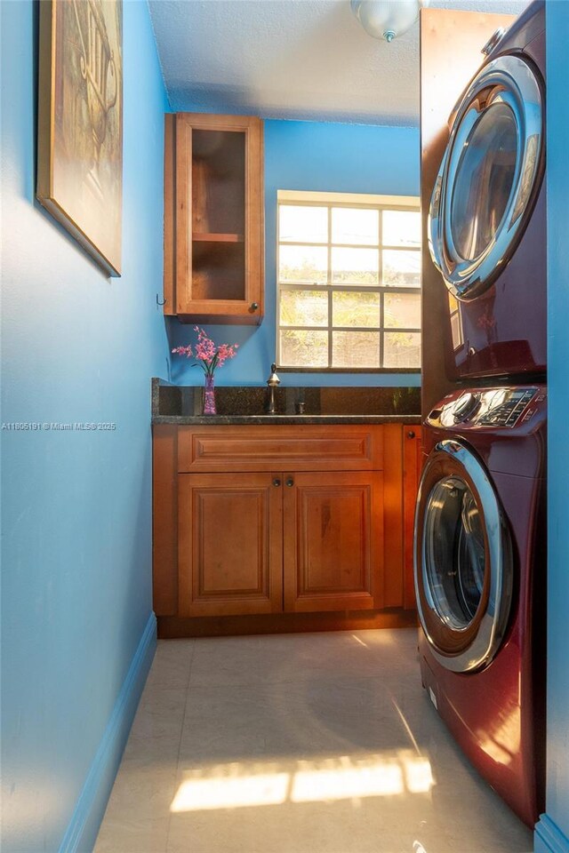 15332 SW 142nd Ter, Miami, FL 33196 - washroom featuring stacked washing machine and dryer and cabinet space