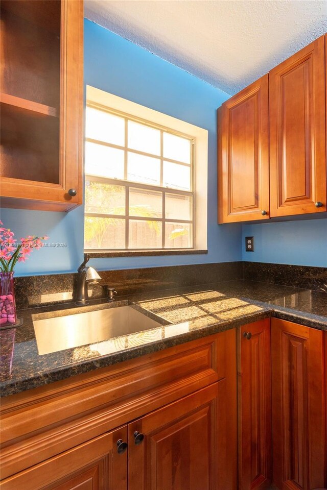 15332 SW 142nd Ter, Miami, FL 33196 - kitchen with dark stone countertops, brown cabinets, and glass insert cabinets