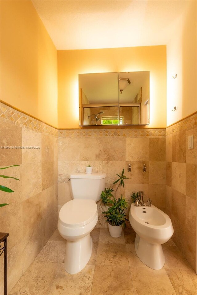 15332 SW 142nd Ter, Miami, FL 33196 - bathroom with tile walls, a bidet, a wainscoted wall, and a shower