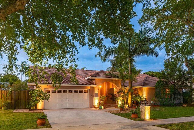 15332 SW 142nd Ter, Miami, FL 33196 - view of front facade featuring an attached garage, a tiled roof, concrete driveway, and stucco siding