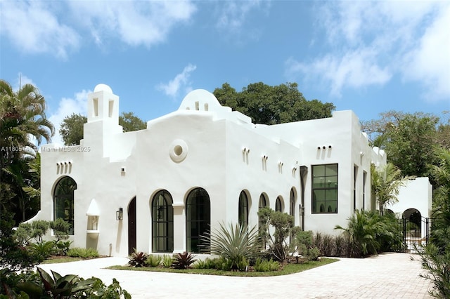 549 NE 59th St, Miami, FL 33137 - view of front facade featuring stucco siding, a gate, and driveway