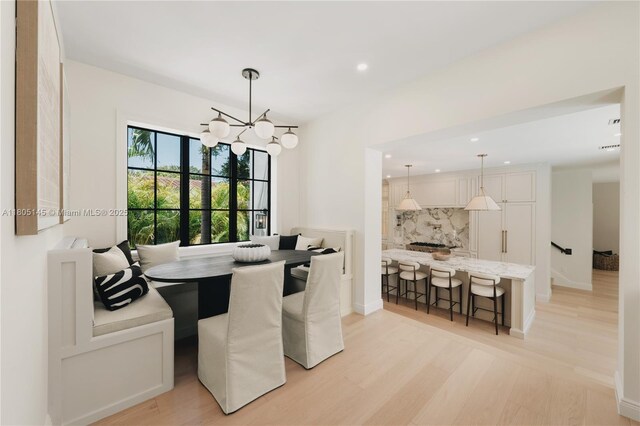 549 NE 59th St, Miami, FL 33137 - dining space with light wood-type flooring, a chandelier, recessed lighting, baseboards, and breakfast area