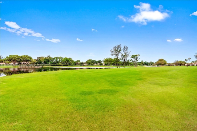 view of yard with a water view and golf course view