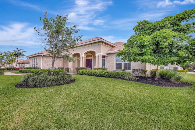 5474 S Sterling Ranch Cir, Davie, FL 33314 - mediterranean / spanish-style home with a tiled roof, a front yard, stucco siding, and stone siding