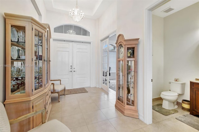 5474 S Sterling Ranch Cir, Davie, FL 33314 - foyer entrance with french doors, a chandelier, light tile patterned flooring, and baseboards