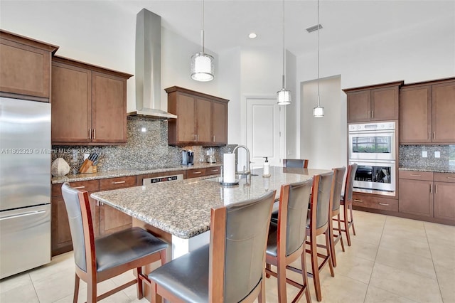 5474 S Sterling Ranch Cir, Davie, FL 33314 - kitchen featuring appliances with stainless steel finishes, a sink, a high ceiling, wall chimney exhaust hood, and backsplash