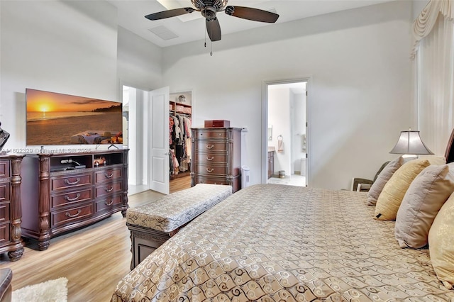 5474 S Sterling Ranch Cir, Davie, FL 33314 - bedroom with light wood-type flooring, a walk in closet, a closet, connected bathroom, and ceiling fan
