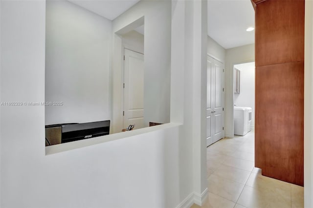 5474 S Sterling Ranch Cir, Davie, FL 33314 - hallway with washer / clothes dryer, light tile patterned floors, and baseboards