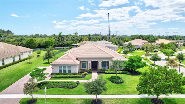 5474 S Sterling Ranch Cir, Davie, FL 33314 - mediterranean / spanish home featuring a tiled roof, a front lawn, stucco siding, and a residential view