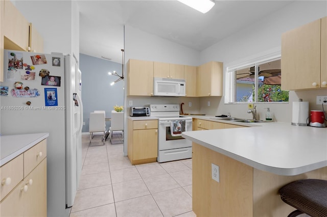 22041 SW 127th Ct, Miami, FL 33170 - kitchen with white appliances, light brown cabinets, a peninsula, light countertops, and vaulted ceiling