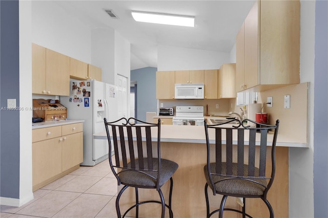 22041 SW 127th Ct, Miami, FL 33170 - kitchen with white appliances, light brown cabinetry, a peninsula, light countertops, and high vaulted ceiling