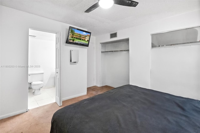 10772 La Placida Dr Unit 7-203, Coral Springs, FL 33065 - carpeted bedroom featuring two closets, ceiling fan, ensuite bath, and tile patterned flooring