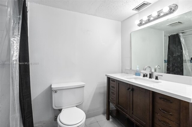 10772 La Placida Dr Unit 7-203, Coral Springs, FL 33065 - bathroom featuring a textured ceiling, toilet, vanity, and tile patterned floors