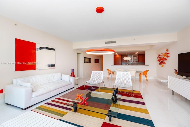 living room featuring light tile patterned floors and baseboards