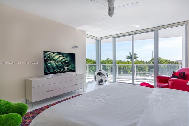 bedroom with access to exterior, expansive windows, and ceiling fan