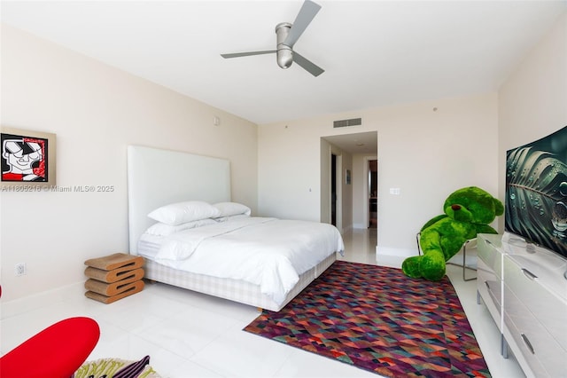 bedroom featuring ceiling fan, tile patterned floors, and baseboards