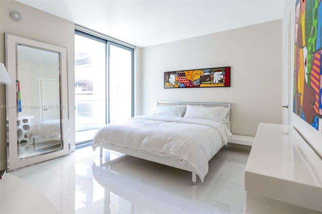 bedroom with multiple windows and access to exterior