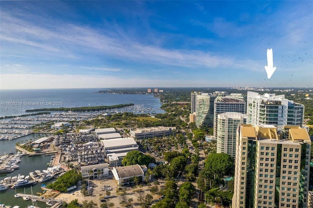 aerial overview of property's location with a nearby body of water, numerous boat docks, and nearby urban area