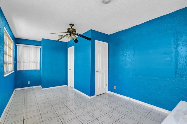 7612 NW 68th Ave, Tamarac, FL 33321 - spare room with a textured ceiling, a ceiling fan, tile patterned floors, and baseboards