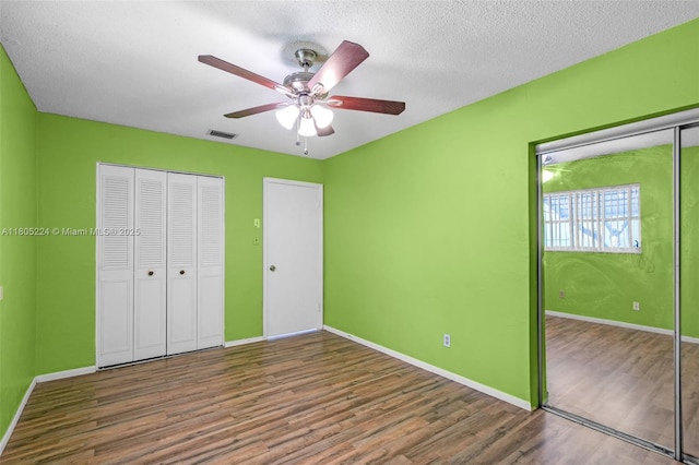 7612 NW 68th Ave, Tamarac, FL 33321 - unfurnished bedroom with wood finished floors, baseboards, a textured ceiling, ceiling fan, and a closet