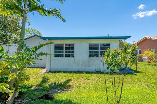 7612 NW 68th Ave, Tamarac, FL 33321 - view of side of property with stucco siding and a lawn
