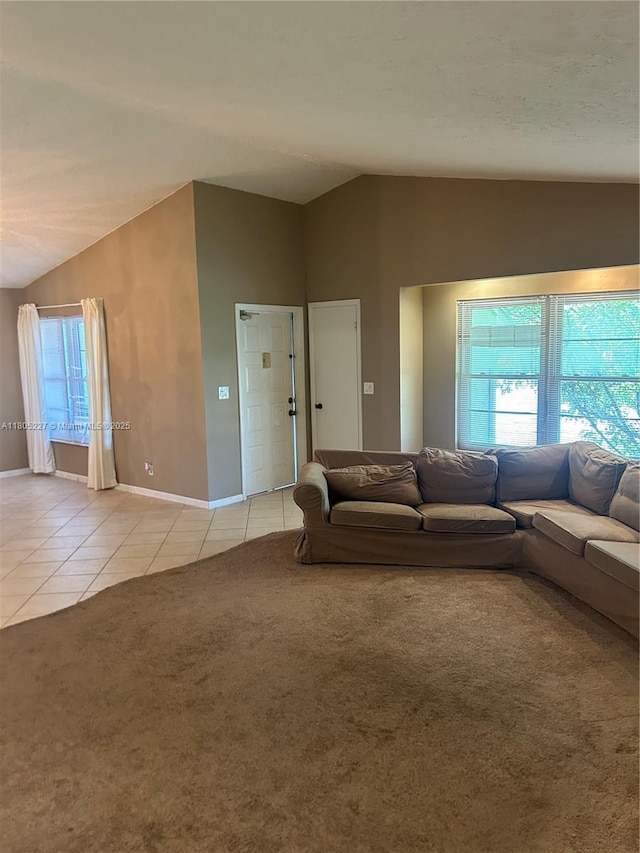 8631 Bridle Path Ct, Davie, FL 33328 - living room with lofted ceiling, light tile patterned floors, baseboards, and light colored carpet